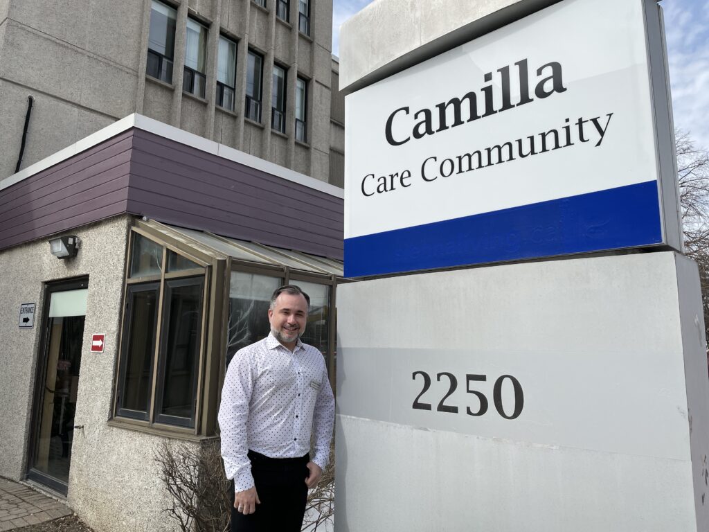 Mario Tsokas standing in front of Camilla Care Community.