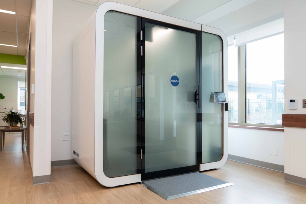 Modern telehealth booth at Partners Community Health facility.