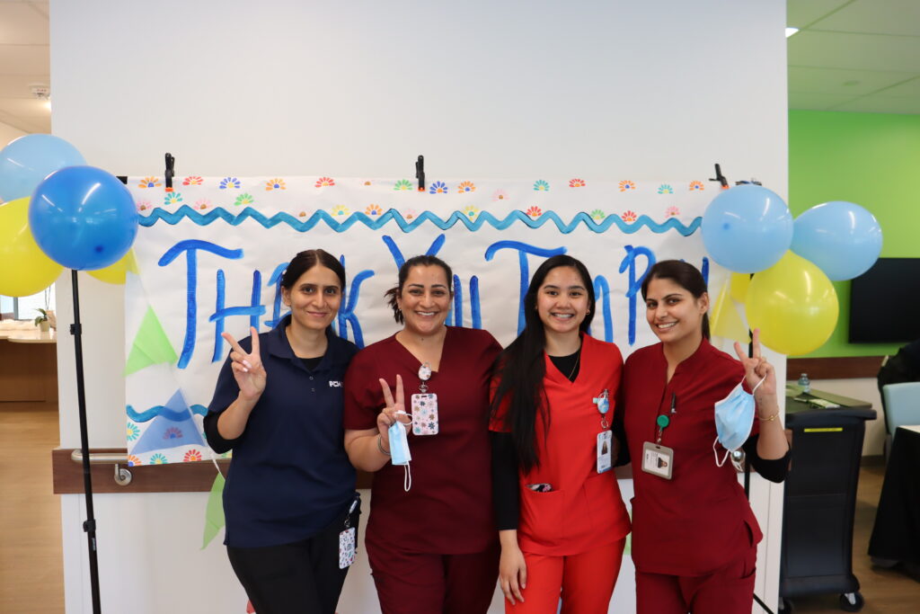 Staff members smiling and posing.